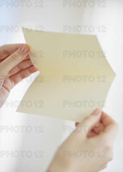 Hands opening a blank card.