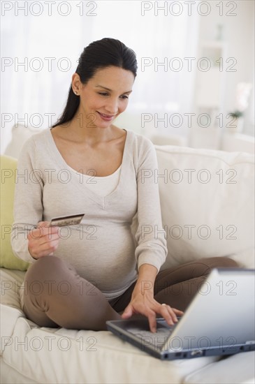 Pregnant woman shopping on-line.