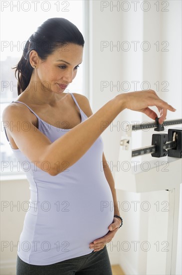 Pregnant woman on scale.