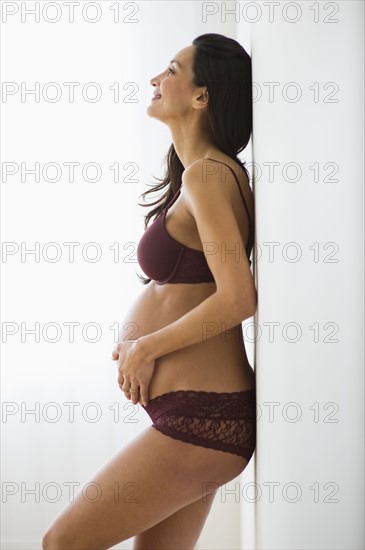 Pregnant woman holding her belly.