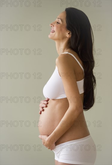 Pregnant woman holding her belly.