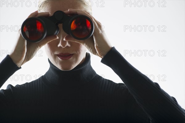 Woman looking through binoculars.