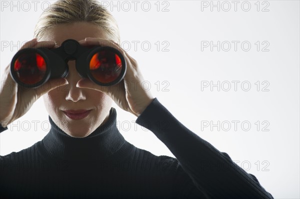 Woman looking through binoculars.