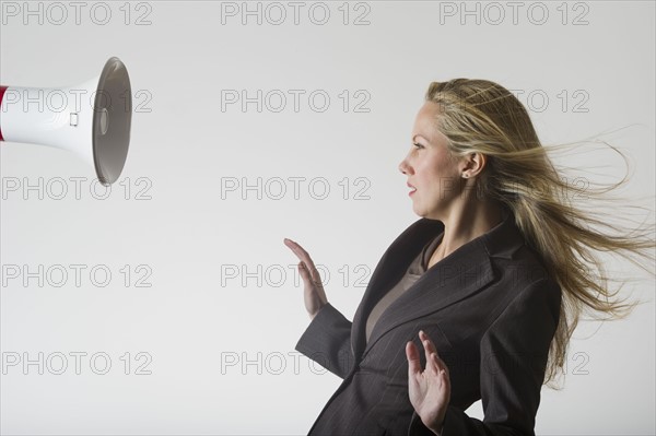 Bullhorn beside businesswoman.