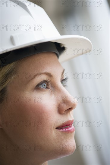 Female architect wearing a hard hat.