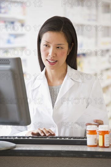 Pharmacist working on computer.