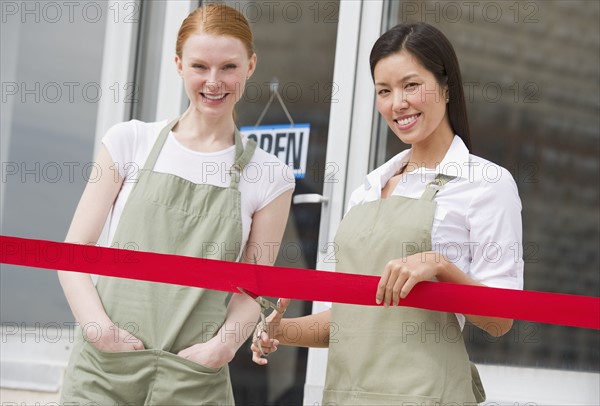 Cutting red ribbon at opening ceremony.