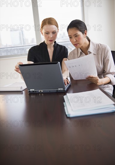 Businesswomen working in conference room.