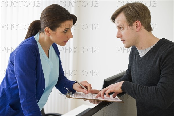 Patient talking to nurse.