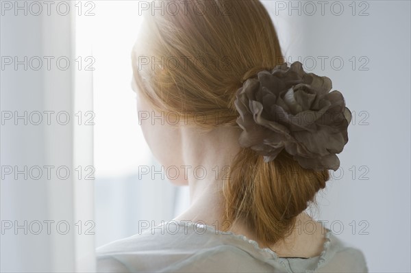 Woman's hair tied with a flower.