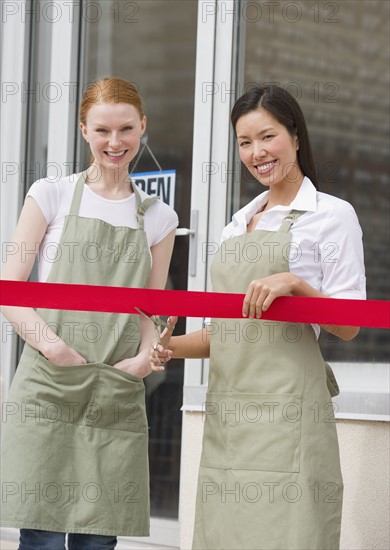 Cutting red ribbon at opening ceremony.