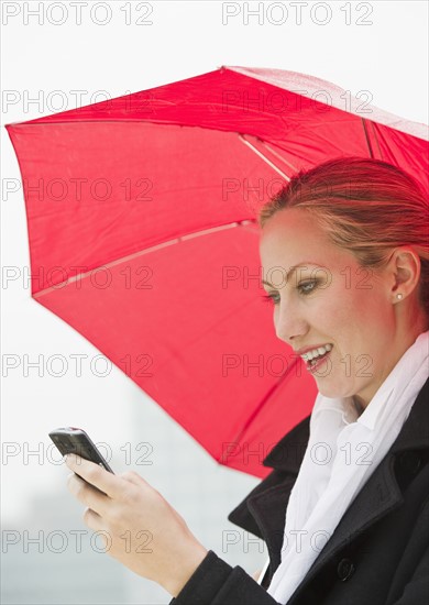 Woman texting on a rainy day.