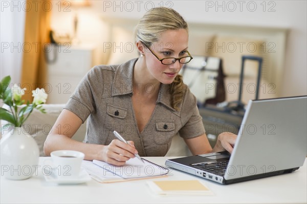 Woman working in hotel room.