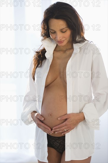 Pregnant woman holding her belly.