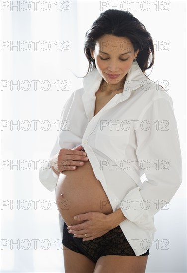 Pregnant woman holding her belly.