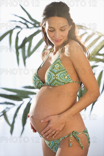 Pregnant woman wearing bikini.