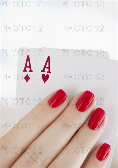 Hand holding a pair of aces.