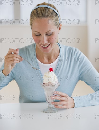 Woman eating ice cream sundae.
