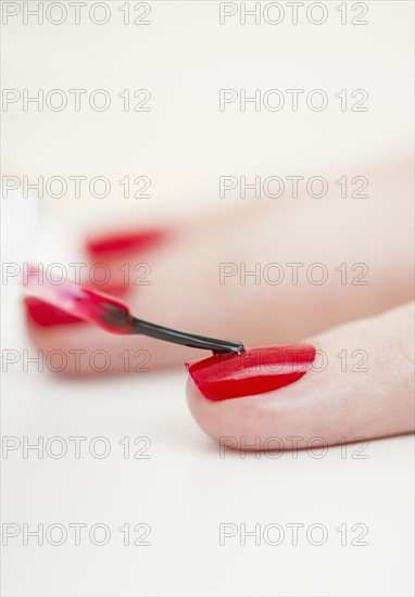 Manicure with red nail polish.