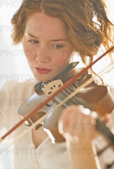 Woman playing violin.