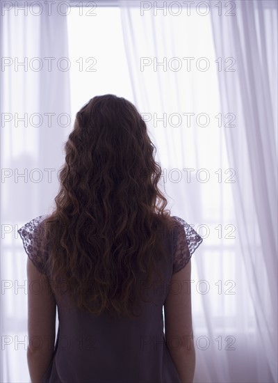 Woman looking out window.