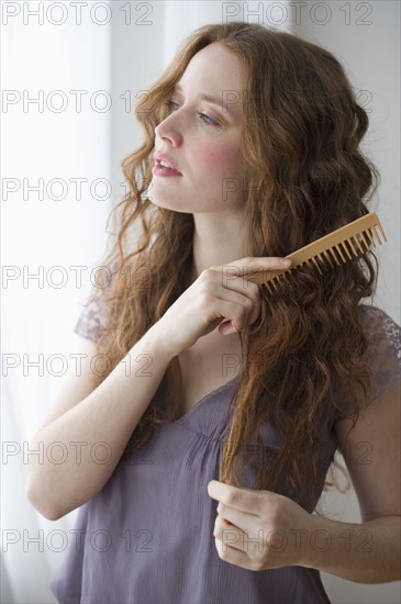 Woman combing her hair.