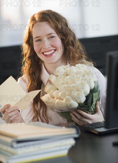 Woman holding bouquet of flowers.