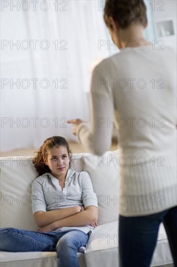 Mother disciplining daughter.