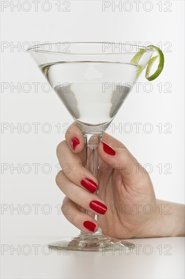 Hand holding martini glass.