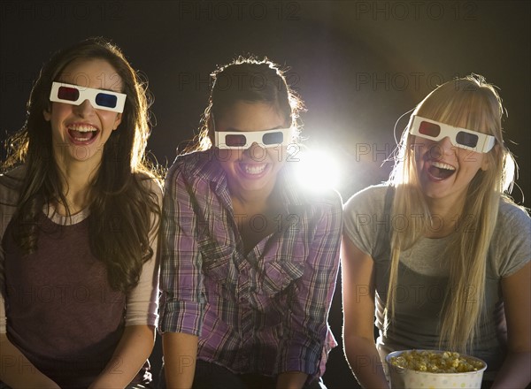 Young girls watching 3D movie.