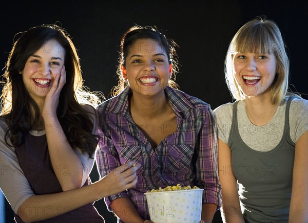 Young girls eating popcorn.