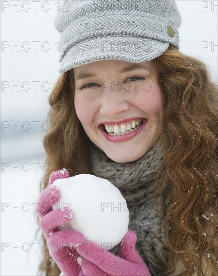 Woman holding a snowball.