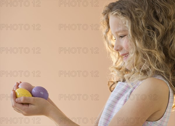 Young girl holding Easter eggs.