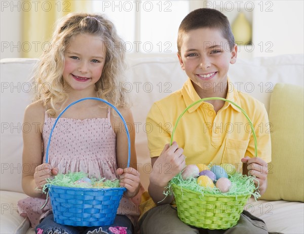 Young children holding Easter baskets.