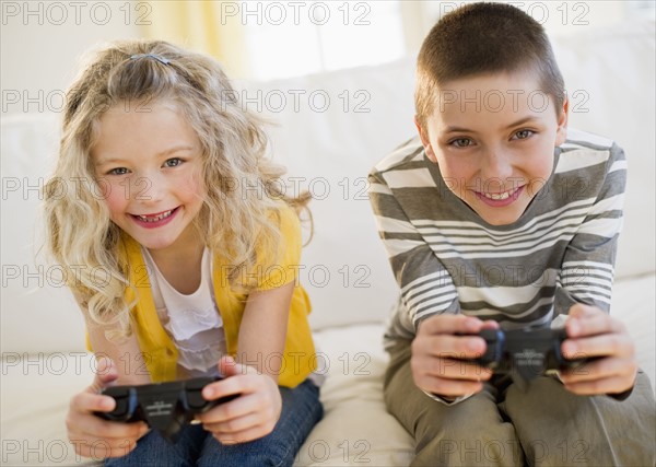 Siblings playing video game.