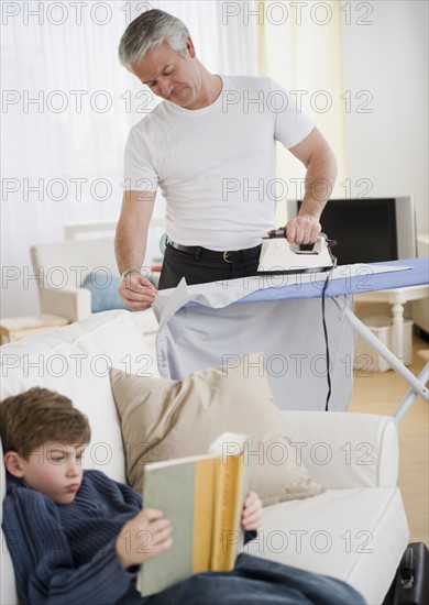 Father ironing. Photographe : Jamie Grill