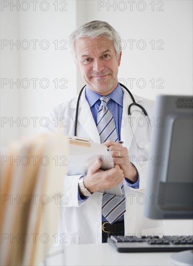 Doctor in his office. Photographe : Jamie Grill