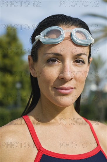 Woman wearing swimming goggles.