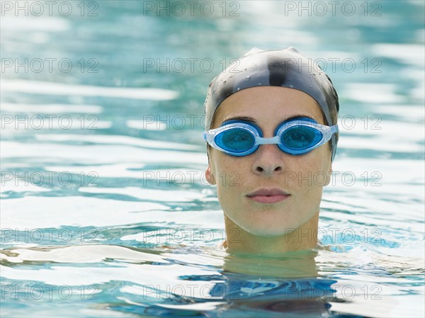 Woman wearing bathing cap and swimming goggles.