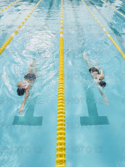 Women swimming laps in pool.