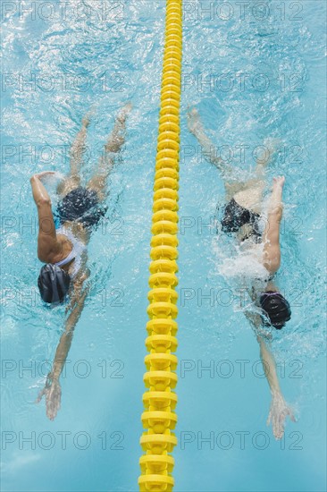 Women swimming laps in pool.