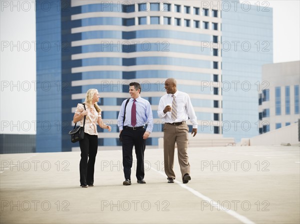 Co-workers walking in parking lot.