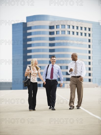 Co-workers walking in parking lot.