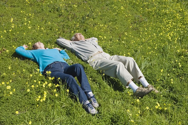 Couple relaxing in meadow.