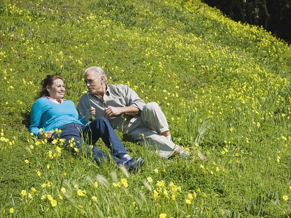 Couple relaxing in meadow.