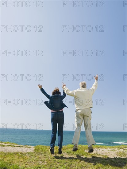 Couple jumping.