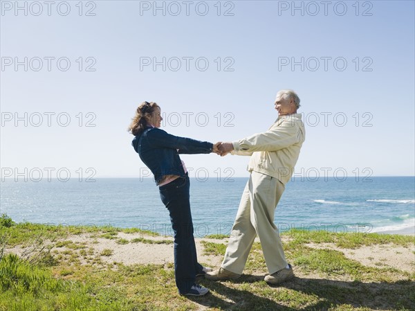 Playful couple by the ocean.