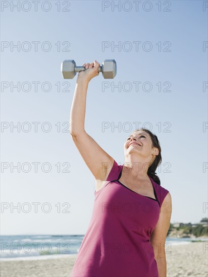 Woman exercising with dumbbell.