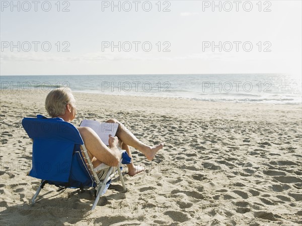 Man relaxing in beach chair.
