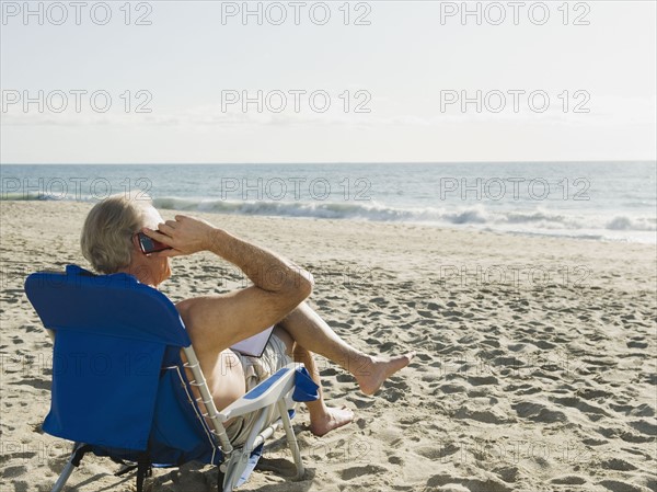 Man relaxing in beach chair.